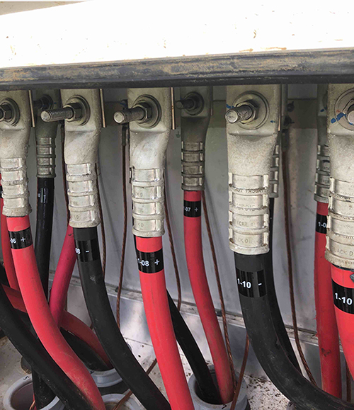 Close-up of inverter electrical connections on a solar project